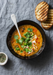 Smoked brisket and red lentil soup on grey background, top view. Comfort winter, autumn food