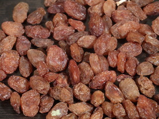 close up of pile of raisins on white background, Kismish, Munnka, Kismish in Whitye Bowl on Wooden Background,Raisins in White Bowl on Wooden Background,