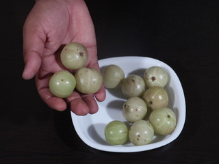 amla green fruits,Indian gooseberry isolated on white background,Amla green fruits ,Phyllanthus emblica isolated on white background, Amla, Amla in Hand on Wooden Background,Gooseberry,