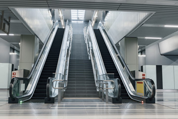 Entrance of moving escalator in modern building to a subway station