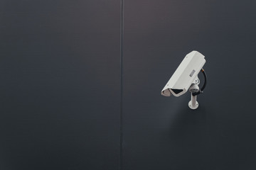 Concept of surveillance and monitoring, modern cctv camera attach to the wall