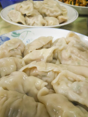 Close up of boiled delicious hot Chinese dumplings on white plate.Chinese dumplings are traditional Asian homemade food in Taiwan.Be background.