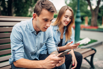 Phone addicted people, couple using smartphones