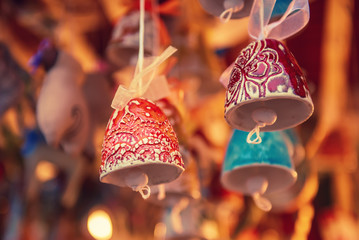 Souvenir christmas ceramic bells at the market, seasonal holiday background