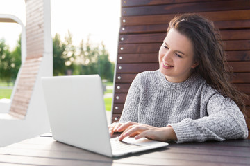 girl looking at laptop screen. Young woman with notebook