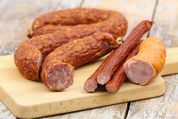 Selection of traditional Polish pork sausages on wooden board
