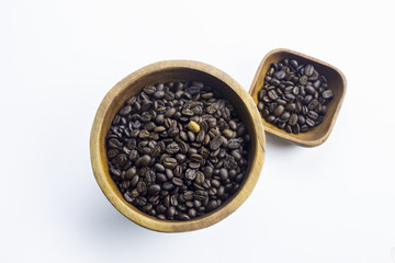 Coffee beans in a wooden Bowl on white background.