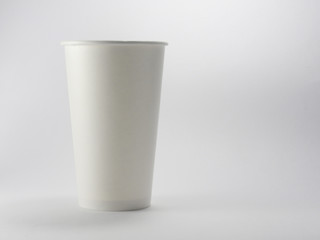 Close up of takeaway white blank paper coffee cup mock up isolated on white background.Disposable tableware is used for hot drink in food store.Although recyclable, it's not eco-friendly to the earth.