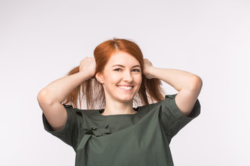 Fototapeta premium Young redhead woman posing on white background