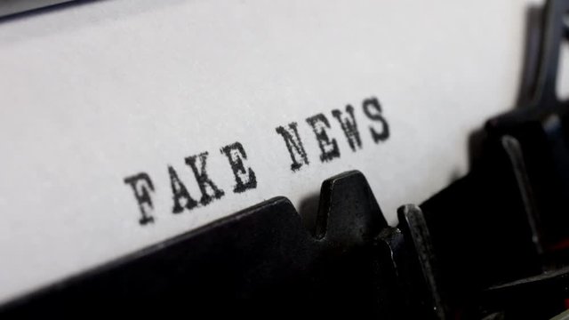 Disinformation and alternative facts. Fake News in black ink being typed on an old manual typewriter.