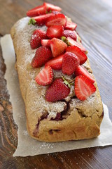 Strawberry cake with fresh berries, sprinkle with powdered sugar, vertical