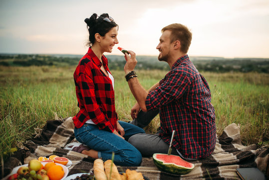 Love couple hugs, picnic in summer field