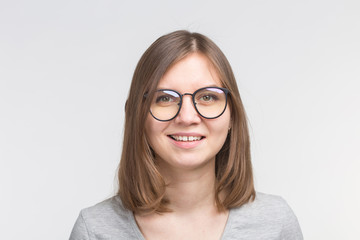 Obraz premium Portrait of laughing happy brown hair woman in a glasses over white background