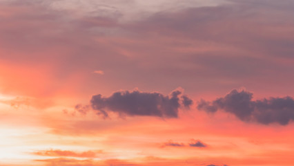 Beautiful dramatic sunset sky with orange and pink colored clouds