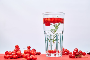 Tasty cold fresh drink, detox water with viburnum berry, rosemary