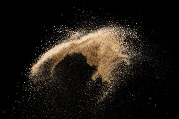Sand flying explosion isolated on black background ,throwing freeze stop motion object design