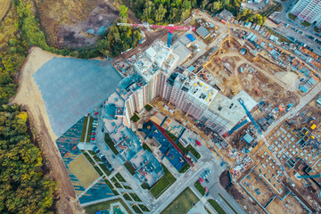 Aerial view from above, construction of modern houses or buildings with cranes and other industrial vehicles
