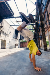 Caucasian fit man practicing handstand at urban place
