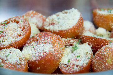 tomato bake with cheese in dish background.