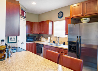 Galley Kitchen with Cherry Cabinets