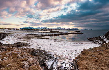 Fototapeta na wymiar Scenic view of beautiful winter sea scandinavian landscape with cloudy sky, mountains and dry grass at Lofoten Islands in Northern Norway