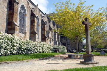 Fototapeta na wymiar Ville de Combourg, jardin de l'église Notre-Dame de Combourg et croix, département d'Ille-et-Vilaine, Bretagne, France