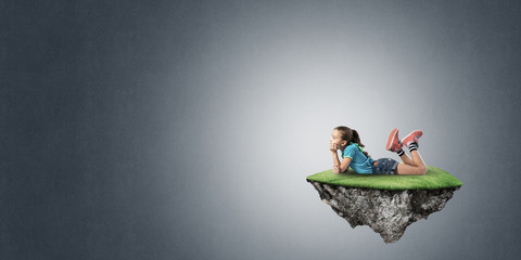 Concept of careless happy childhood with girl on floating island © adam121