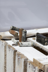 Used finger-wound batteries covered with corrosion. They lie on a wooden box. Recycling.