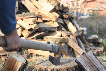Lumberjack chopping wood for winter, Young man chopping woods with old ax