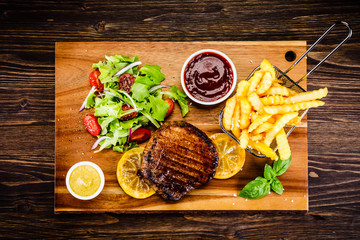 Grilled beefsteak with french fries and vegetables
