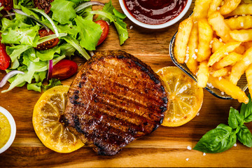 Grilled beefsteak with french fries and vegetables