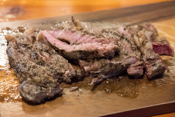 Medium rare meat on plate with sauce