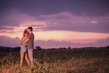 Young couple hugging in romantic evening