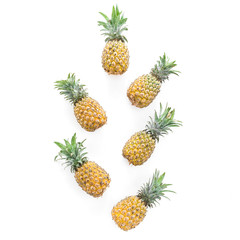 Sweet pineapple fruits arrangement on white background. Flat lay, top view. Tropical fruit composition.