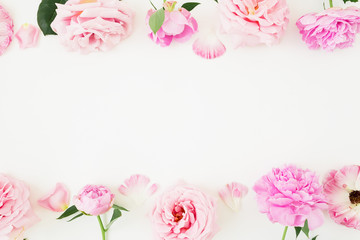 Floral frame of pink pastel flowers on white background. Flat lay, Top view. Flowers texture.