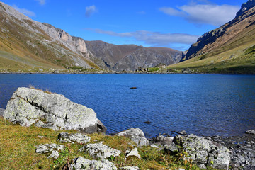 Russia, Arkhyz. Lake Zaprudnoye in autumn in sunnny day