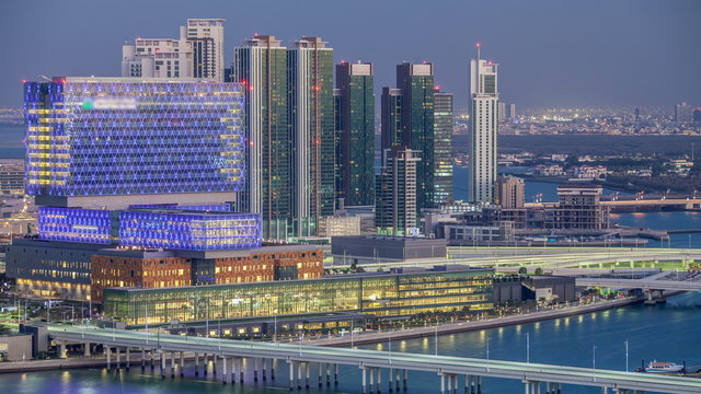 Aerial skyline of Abu Dhabi city centre from above day to night timelapse
