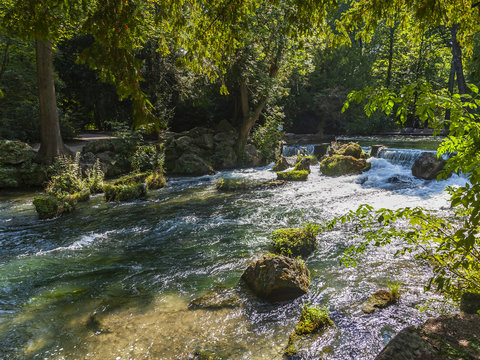 Munich, Germany, on August 22, 2018. Park with stream and artificial wave