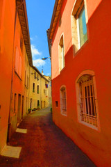Fototapeta na wymiar Narrow street of red colorful buildings