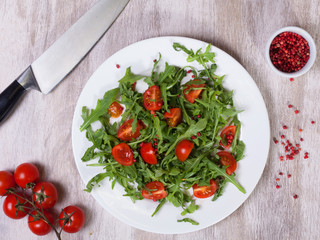 Top view of a salad of tomatoes and arugula