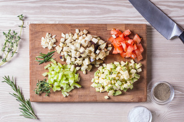 Diced different vegetables on a wooden board