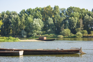 wooden boat with sail moored