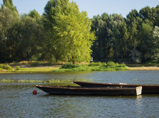 wooden boat with sail moored