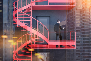 Businessman standing on emergency exit stairs