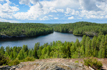 A view from the cliff over forest and lake in Finland. - 225064415