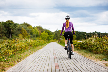 Fototapeta na wymiar Young woman cycling