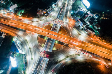 Background scenic road, The light on the road roundabout at night and the city in Bangkok, Thailand. Aerial view. Top view. 