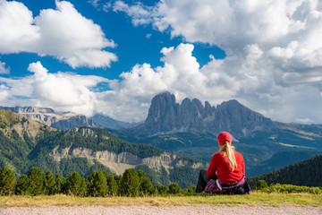 Naklejka premium Sporty Young woman on mountain trail Dolomites Mountains, Italy