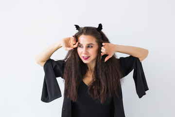 Excited happy young woman in halloween costume posing in lightroom