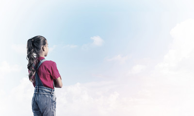 Concept of careless happy childhood with girl looking in future